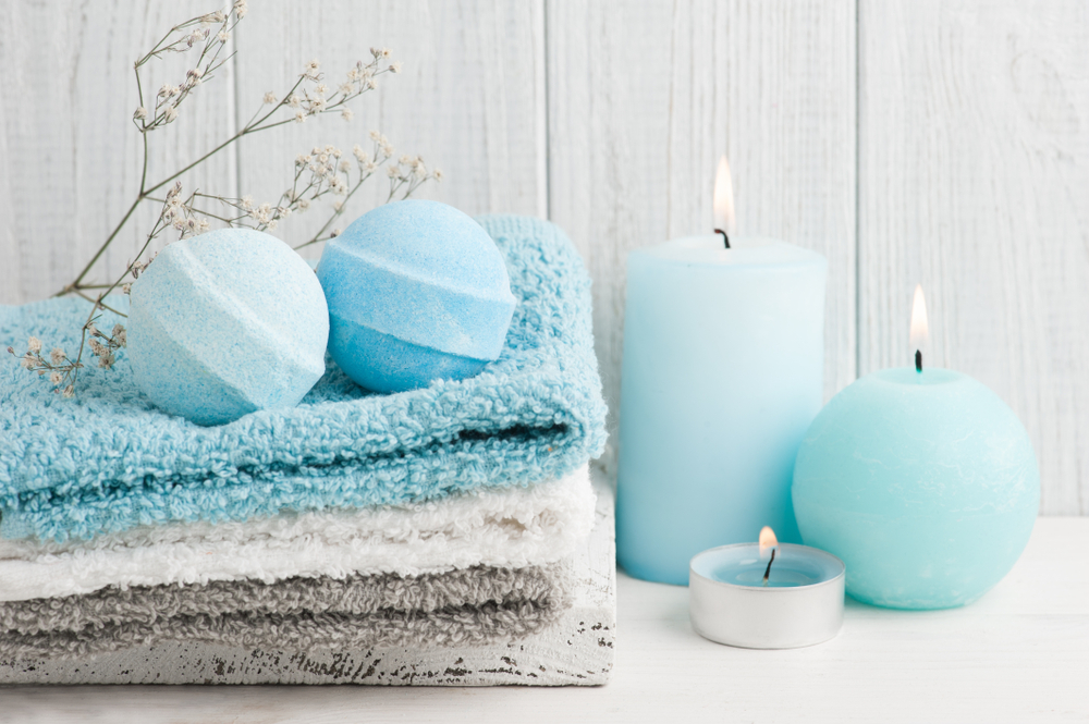 Spa,Composition,With,Blue,Bath,Bombs,,Candles.,Wooden,Background