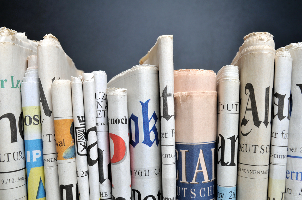 Variety of newspaper on a shelf