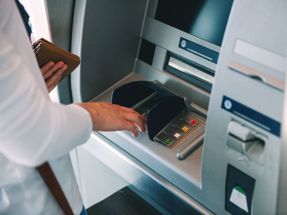 Woman,Using,Atm,Holding,Wallet,An,Pressing,The,Pin,Security